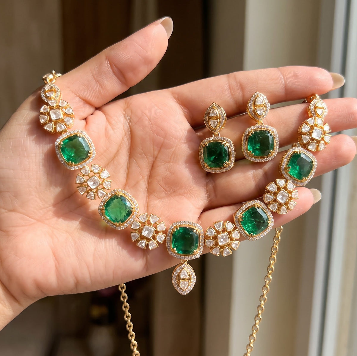 ZEVARAZ Aabha Panna necklace set, held in hand with the earrings