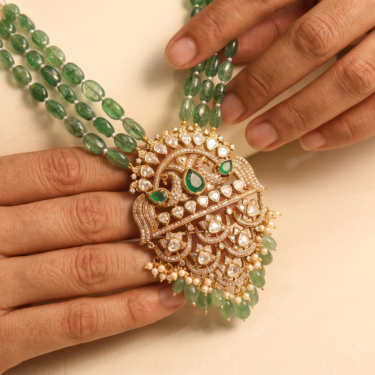 Hand adjusting the ZEVARAZ Aabha Padak Necklace Set, close detail of the medallion