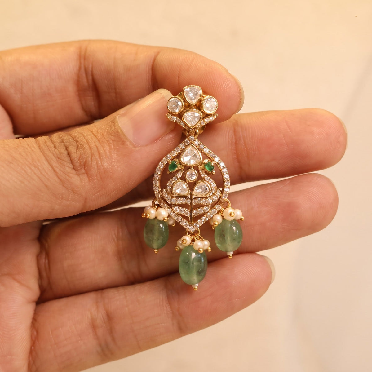 ZEVARAZ Aabha Padak Necklace Set earring held in hand, showing its scale