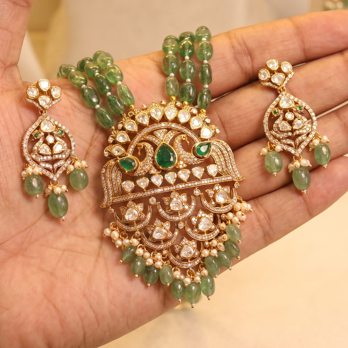 ZEVARAZ Aabha Padak Necklace Set resting on a palm with both earrings