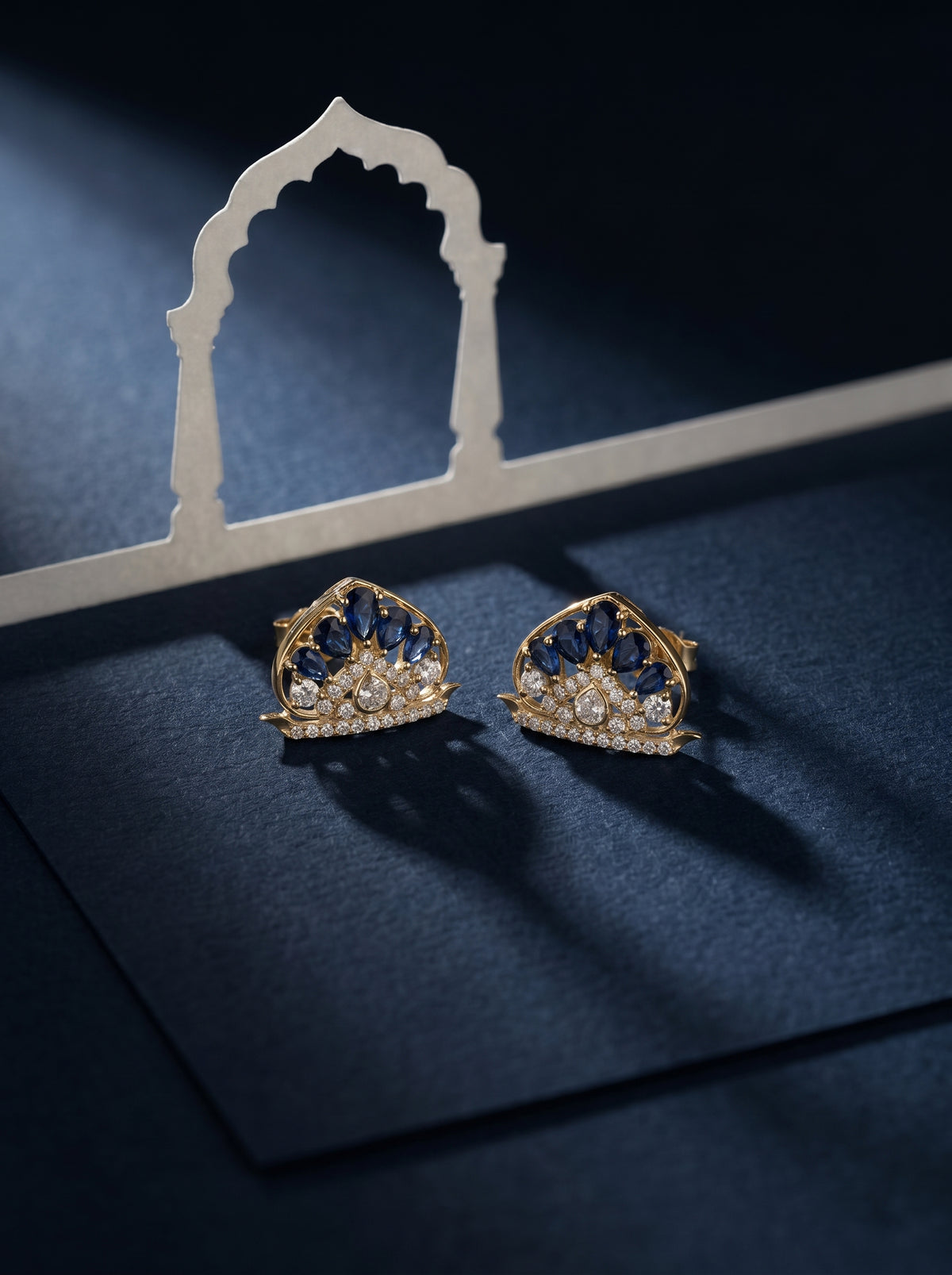 ZEVARAZ Ratna Jaya Studs styled against a navy backdrop with an arch prop