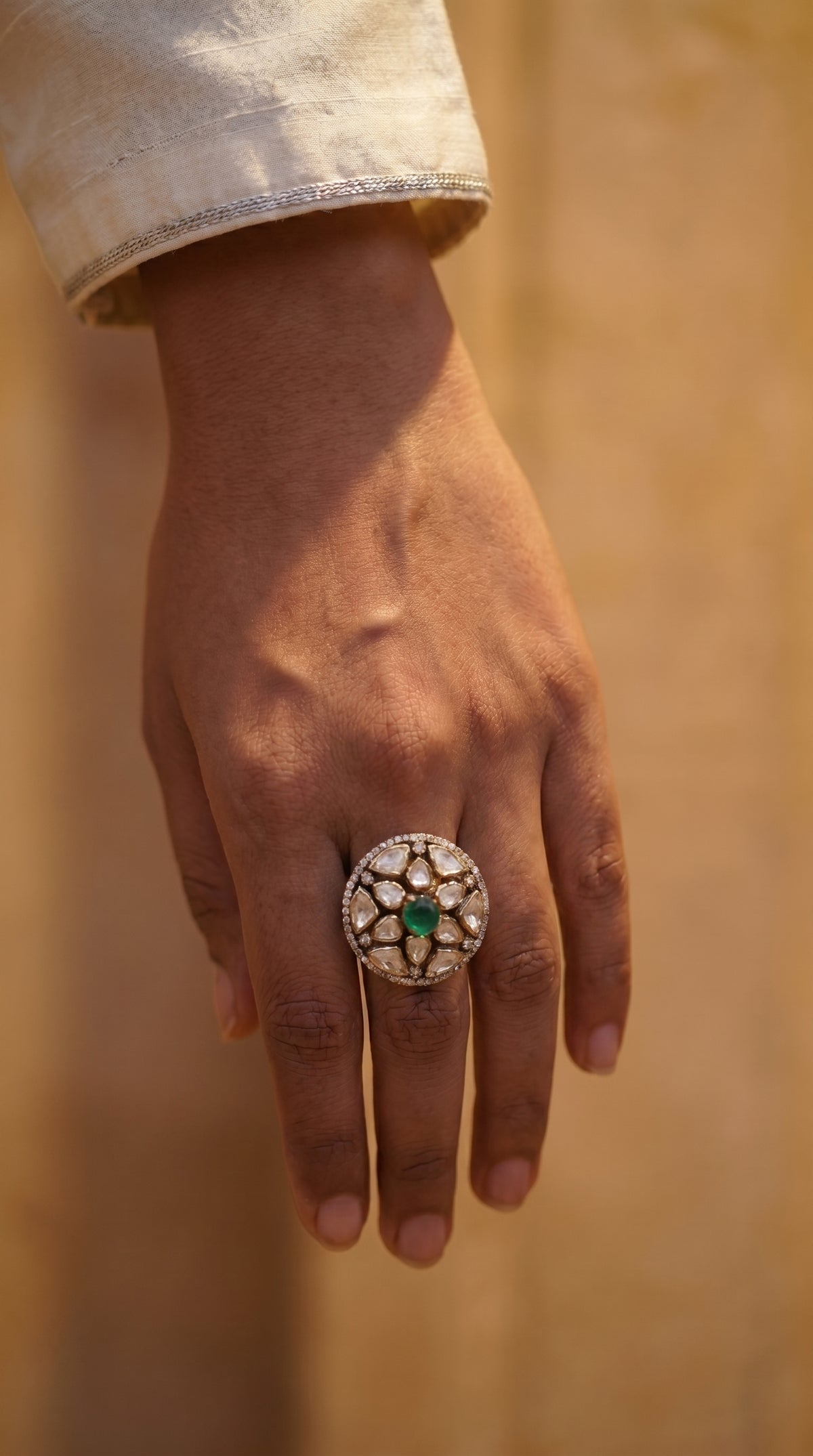 Close-up of a hand wearing the ZEVARAZ Aabha Panna Chandra Kundan Silver Ring